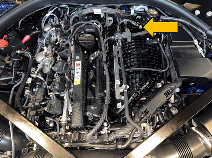 BMW 3.0L (S58) engine with arrow to location of the vacuum line