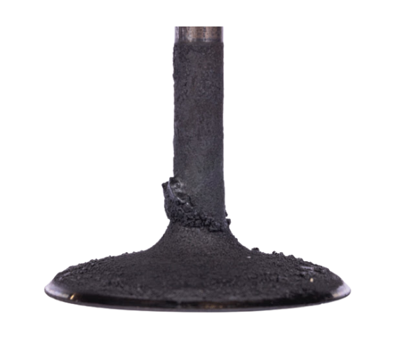 Why do carbon deposits form in modern engines?