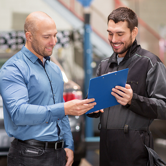 auto mechanic and customer at car shop