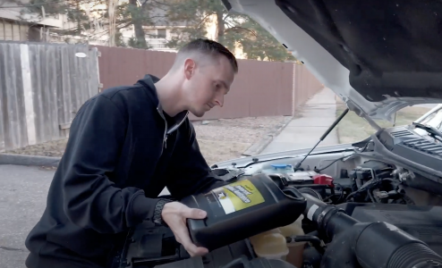 Jon Hansen pouring coolant in the reservoir.